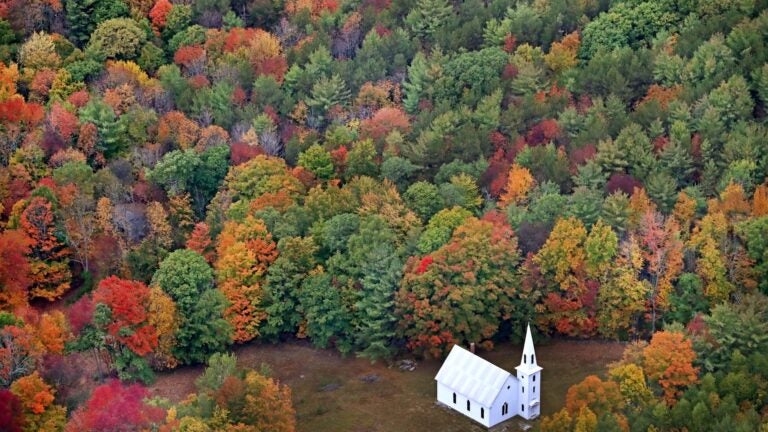 Fall foliage surrounds a small church near East Parsonsfield, Maine.