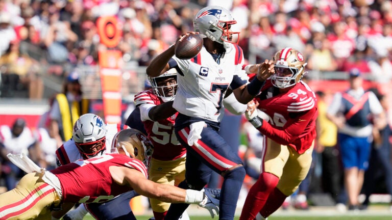 New England Patriots quarterback Jacoby Brissett (7) looks to pass while pressured by San Francisco 49ers defensive end Nick Bosa, bottom, defensive end Leonard Floyd, middle left, and defensive end Yetur Gross-Matos (94) during the second half of an NFL football game in Santa Clara, Calif., Sunday, Sept. 29, 2024.