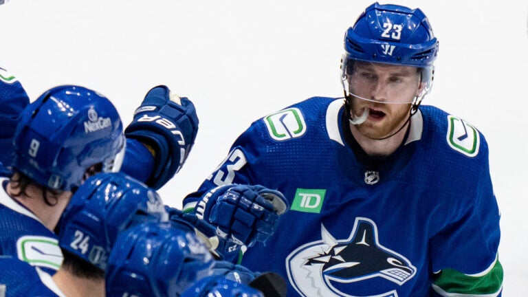 Vancouver Canucks' Elias Lindholm is congratulated for his goal against the Edmonton Oilers during the second period of Game 1 of a second-round NHL hockey Stanley Cup playoffs series, Wednesday, May 8, 2024, in Vancouver, British Columbia.