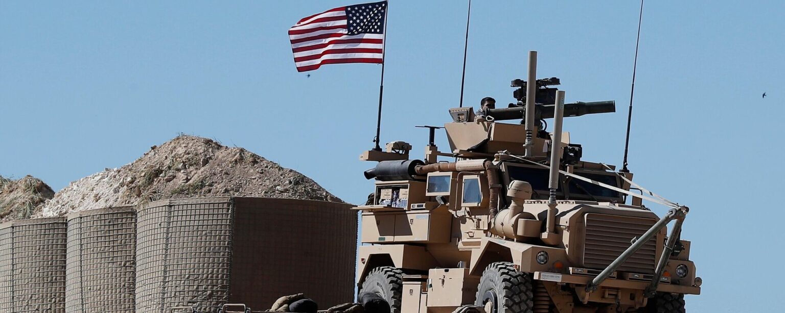 In this April 4, 2018, file photo, a U.S. soldier sits on an armored vehicle on a newly installed position, near front line between the U.S-backed Syrian Manbij Military Council and the Turkish-backed fighters, in Manbij, north Syria - Sputnik International, 1920, 27.09.2024