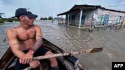 A man rows a boat in a flooded street after the passage of Hurricane Helene in Guanimar, Artemisa province, Cuba, on Sept. 25, 2024.