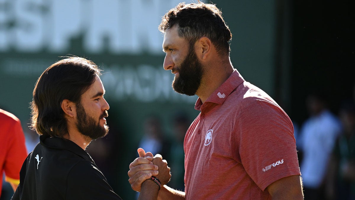 Angel Hidalgo of Spain shakes hands with Jon Rahm of Spain on the 18th hole on day four of the Acciona Open de España presented by Madrid 2024