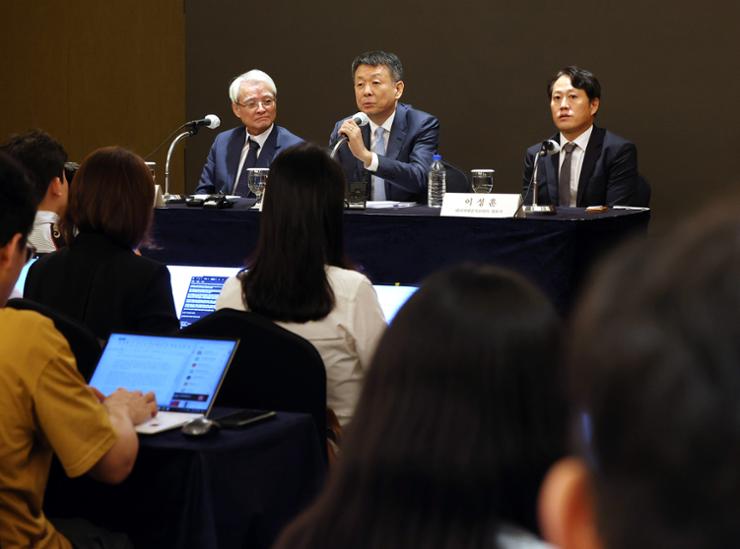 Kim Kwang-il, center, a partner at MBK Partners, speaks during a press conference at Lotte Hotel Seoul, Sept. 19. Yonhap