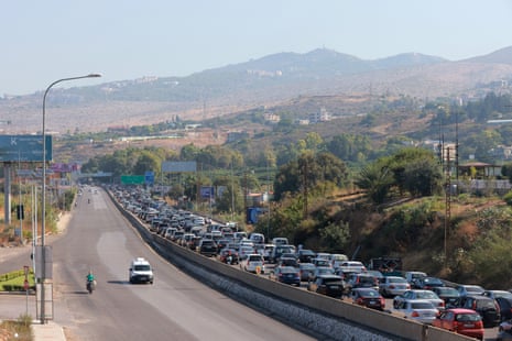 Vehicles wait in traffic in the town of Damour, south of the capital Beirut on 24 September as people flee southern Lebanon.