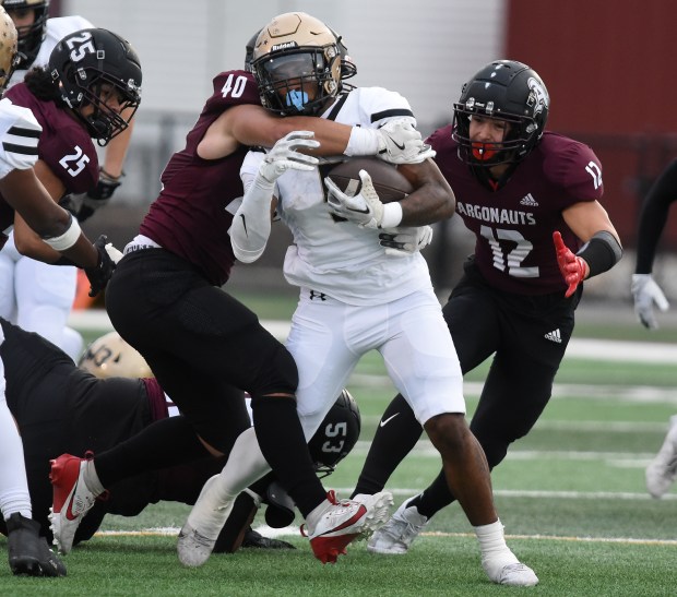 Richards' Myles Mitchell (5) tries to break free from Argo's Jakub Jarosz (4) tackle during a South Suburban Red game Friday, Sept. 27, 2024 in Summit, IL. (Steve Johnston / Daily Southtown)