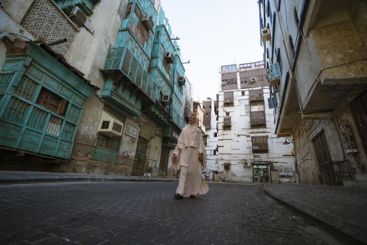 A woman walks the street of Old Town Jeddah, Saudi Arabia. Courtesy of the Embassy of Saudi Arabia in Seoul