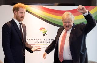 Prince Harry talks with then-Prime Minister Boris Johnson during a bilteral meeting at the UK-Africa Investment Summit in London on January 20, 2020.