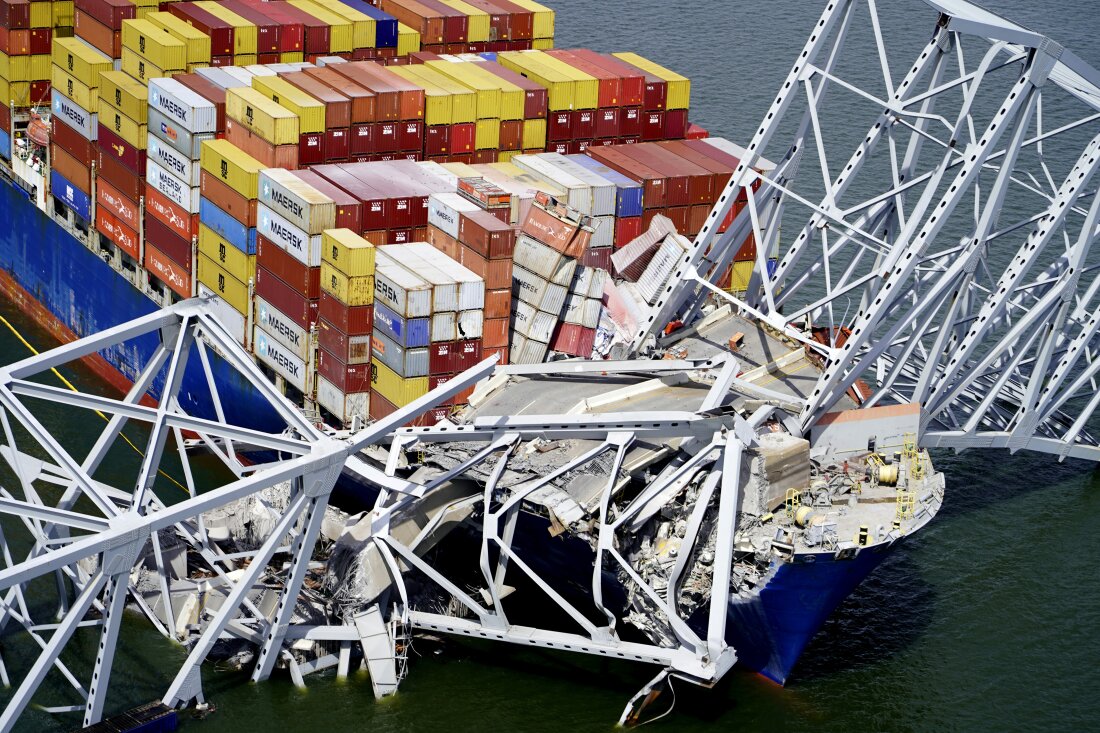 In this aerial image released by the Maryland National Guard, the cargo ship Dali is stuck under part of the structure of the Francis Scott Key Bridge after the ship hit the bridge on March 26 in Baltimore.