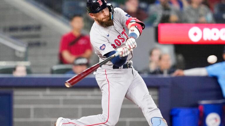 Trevor Story of the Red Sox hits an RBI double against the Blue Jays in the 10th inning.