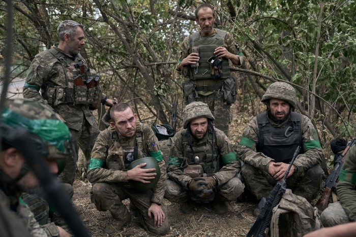 Ukrainian troops rest in the bushes in the Pokrovsk region