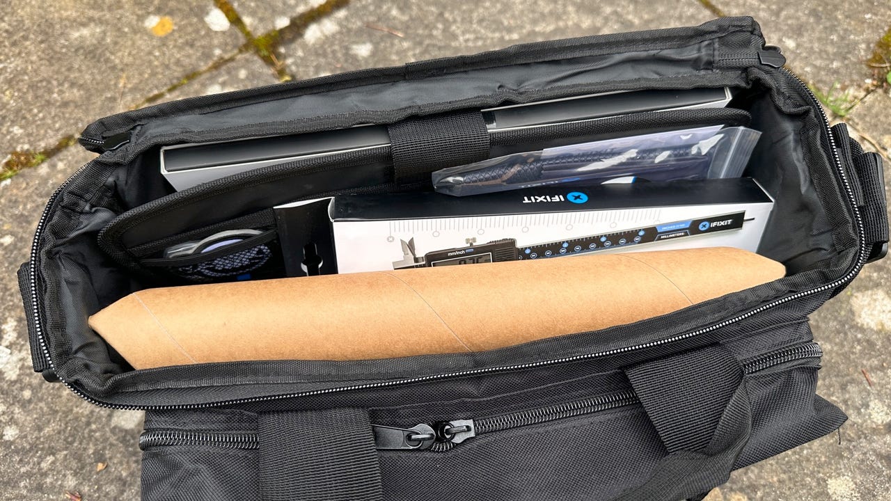 A messenger bag filled with an assortment of tools