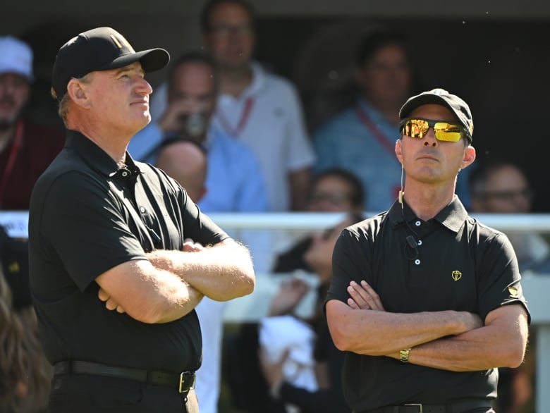 Two golfers on the tee.