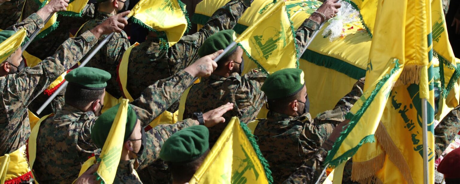 Hezbollah fighters raise their group flags, as they salut the coffin of their comrade Mohammed Tahhan who was shot dead on Friday by Israeli forces along the Lebanon-Israel border, during his funeral procession, in the southern village of Adloun, Lebanon, Saturday, May 15, 2021 - Sputnik International, 1920, 28.09.2024