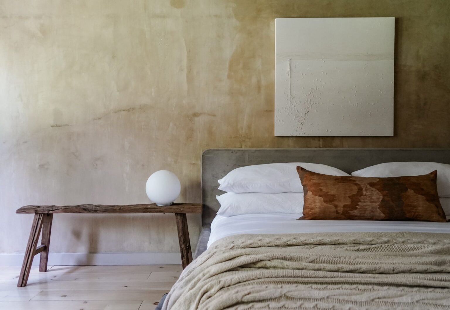 Bedroom in earthy colors at AWOL Stowe hotel in Stowe Vermont.