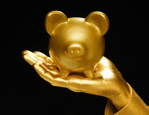 Golden hand and piggie bank