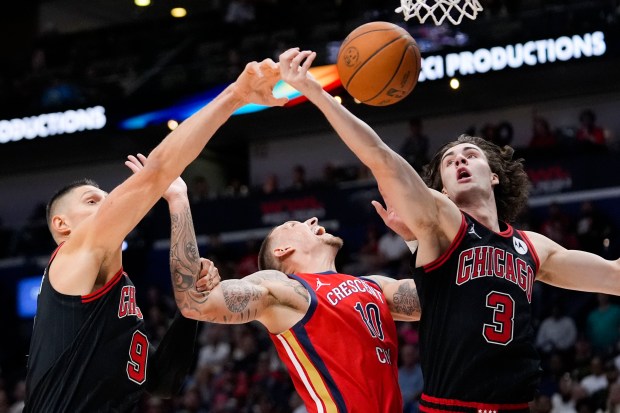 Pelicans center Daniel Theis (10) battles under the basket between Bulls center Nikola Vučević, left, and guard Josh Giddey in the first half on Oct. 23, 2024, in New Orleans. (Gerald Herbert/AP)