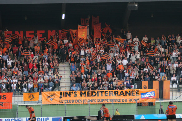 Narbonne supporters show their passion in the club’s distinctive orange colours at Parc des Sports et de l’Amitié.