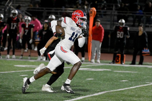 West Aurora's Kewon Marshall (11) runs the ball in for a touchdown against East Aurora in Aurora on Friday, Oct. 18, 2024. (Mark Black / for the Beacon-News)