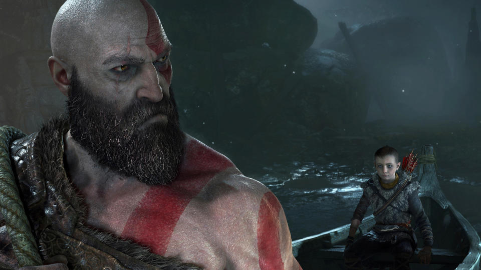 Kratos and Atreus in a still from God of War. Atreus sits in a boat while Kratos looks grimdark.