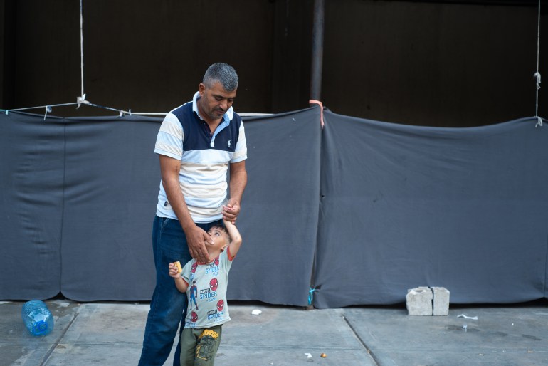 Syrian refugee with one of his sons.