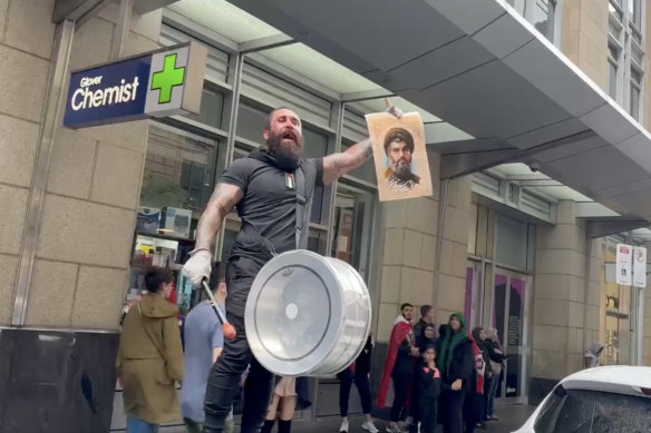 A demonstrator holds an image of slain Hezbollah leader Hassan Nasrallah at a protest in Sydney on Sunday.