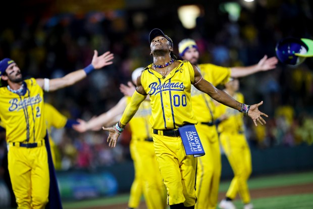 First-base coach Maceo Harrison leads the Savannah Bananas in a dance on Aug. 16, 2024, at Harbor Park in Norfolk, Va. (Billy Schuerman/The Virginian-Pilot)