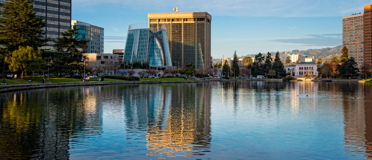 Lake Merritt in Oakland shimmering with reflections of buildings in the water.