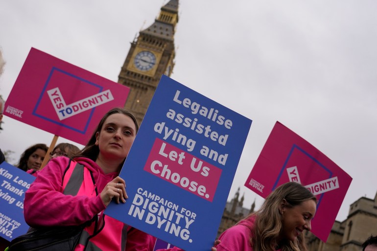 A small demonstration by people advocating assisted dying hold a protest outside the Hoses of Parliament as a bill to legalise assisted dying is to be put before lawmakers in London,