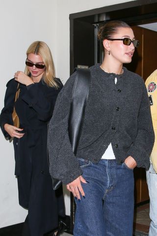 Hailey Bieber and Kendall Jenner leave sushi park where Hailey wears a button up gray sweater by Leset