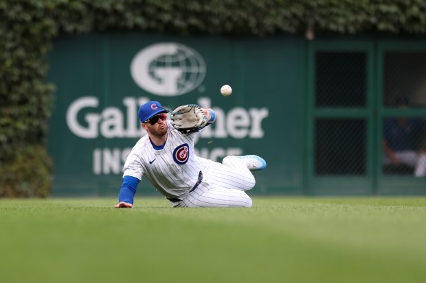 Chicago Cubs outfielder Ian Happ (8) makes a diving catch in the seventh inning against the Milwaukee Brewers at Wrigley Field on July 24, 2024. (Eileen T. Meslar/Chicago Tribune)