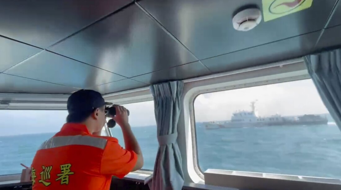 In this screen grab from video released by the Taiwan Coast Guard, a member of the Taiwan Coast Guard monitors a China Coast Guard boat as it passes near the coast of Matsu islands, Taiwan on Monday, Oct. 14, 2024.