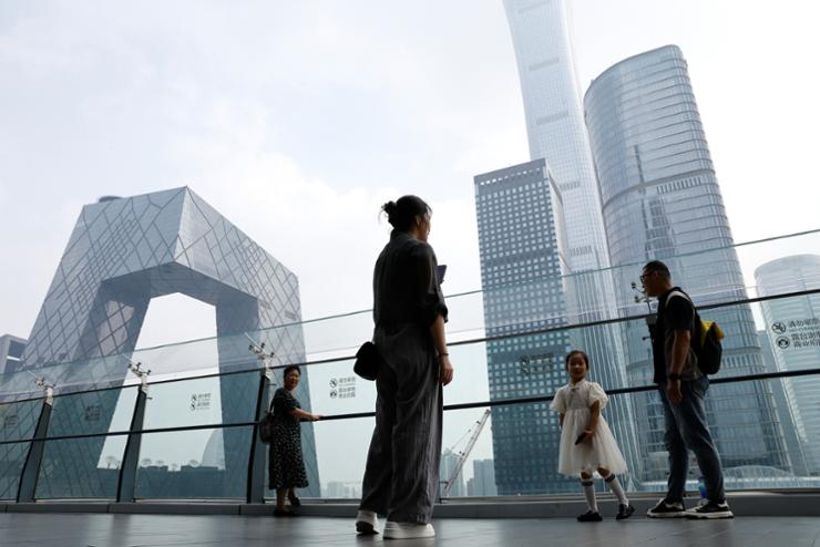 People stand at a shopping mall near the CCTV headquarters and China Zun skyscraper, in Beijing's central business district (CBD), China Sept. 7, 2023. Reuters-Yonhap