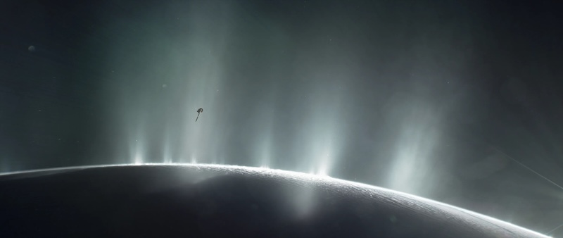 Complex organics on Enceladus: Shadowed edge of planet-like body with several bright plumes erupting from the surface. A small spacecraft is close to the plumes.