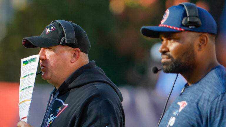 New England Patriots offensive coordinator Alex Van Pelt calling the plays in front of head coach Jerod Mayo against the Miami Dolphins during fourth quarter NFL action at Gillette Stadium.