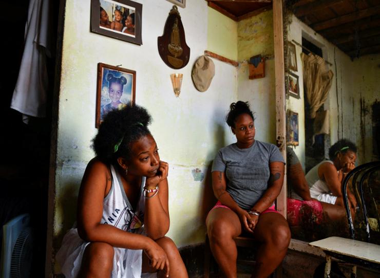 Oney Machado and Diana Machado sit in the house as Cuba suffers a third major setback in restoring power to the island, with millions still in the dark, in Havana, Cuba, Oct. 20. Reuters-Yonhap