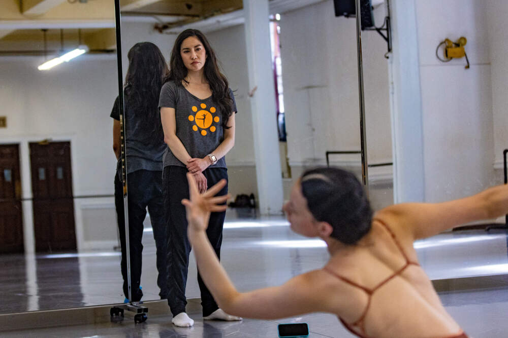 Elizabeth Mochizuki watches Asian American Ballet Project dancer Rheya Shano as she rehearses for an upcoming performance. (Jesse Costa/WBUR)