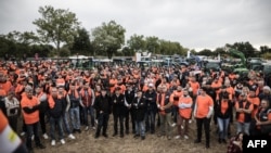 FILE - Cognac winegrowers gather before a demonstration against the threat of Chinese tariffs, in Gensac-la-Pallue, France, on Sept. 17, 2024.