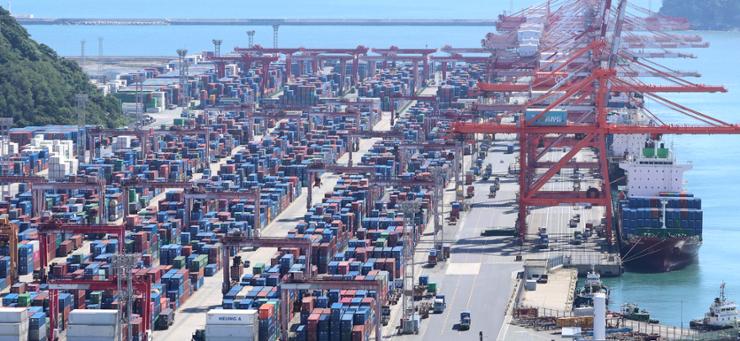 Shipping containers are stacked at a port in the southeastern city of Busan, Sept. 30. Yonhap