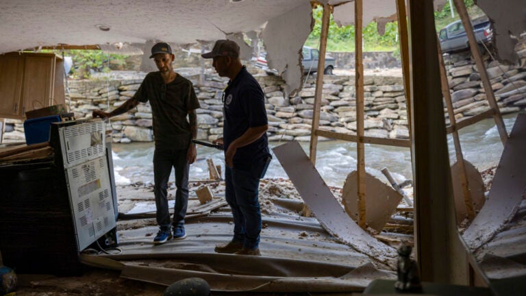 FEMA employee Jirau Alvaro works with Daniel Mancini, doing a report on the damage to his property on Sunday, Oct. 6, 2024 in rural Buncombe County, near Black Mountain, N.C.