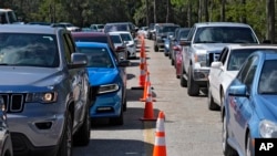 Motorists wait in long lines for fuel at a newly opened depot after Hurricane Milton on Oct. 12, 2024, in Plant City, Florida.