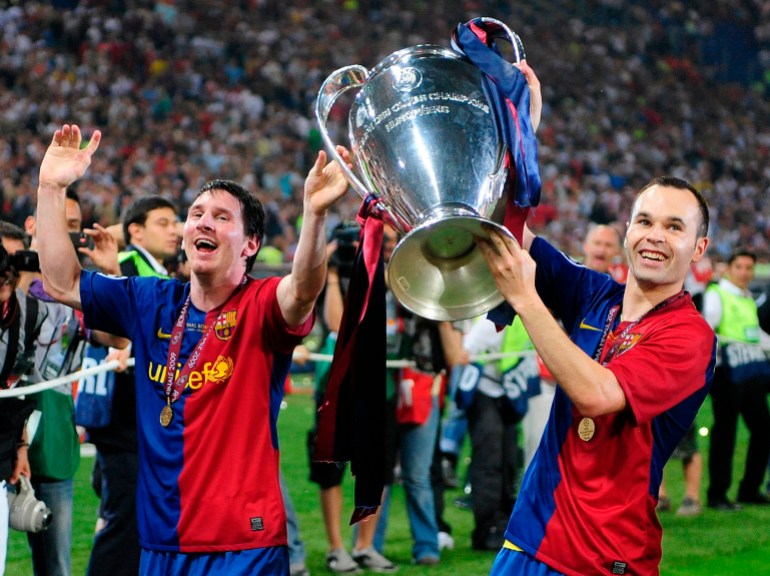 FILE - Barcelona's Andres Iniesta, right, and Lionel Messi hold the trophy at the end of the Champions League final soccer match between Manchester United and Barcelona in Rome, on May 27, 2009. Andres Iniesta who scored Spain's World Cup-winning goal in 2010 and was one of the key players who made Barcelona's tiki-taka thrive for so long, announced his retirement from soccer on Tuesday. (AP Photo/Manu Fernandez, File)