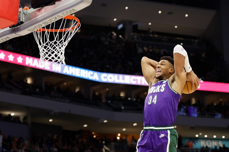 NBA player dunks the ball.