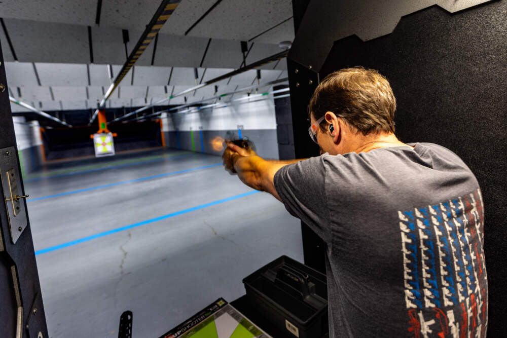 Toby Leary shoots a tactical pistol during a demonstration at the Cape Gun Works firing range of guns no longer allowed to be sold under the state's new gun control law. (Jesse Costa/WBUR)