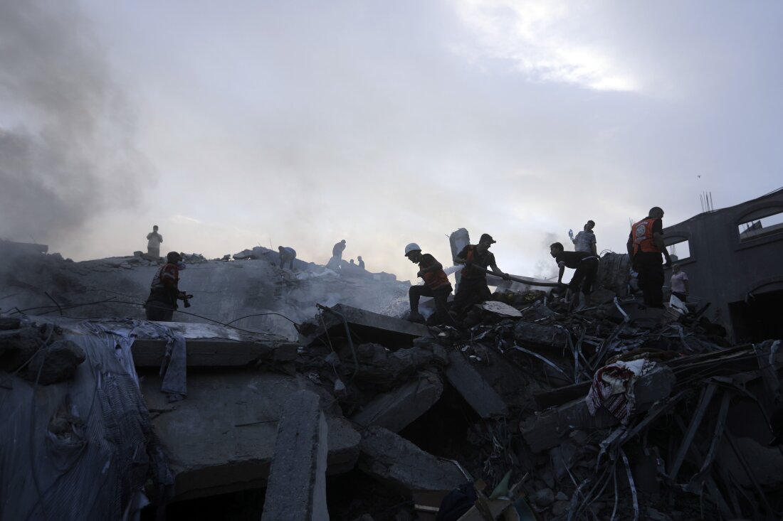 Palestinians look for survivors under the rubble of a destroyed building following Israeli airstrikes in Nuseirat, central Gaza Strip, Oct. 31, 2023.