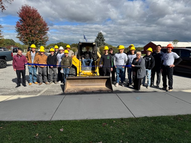 Students and others involved in the new Porter County Career and Technical Education civil construction program pose on dry pavement Wednesday at Sunset Hill Farm County Park. The students are learning how to build roads and bridges. (Doug Ross/Post-Tribune)