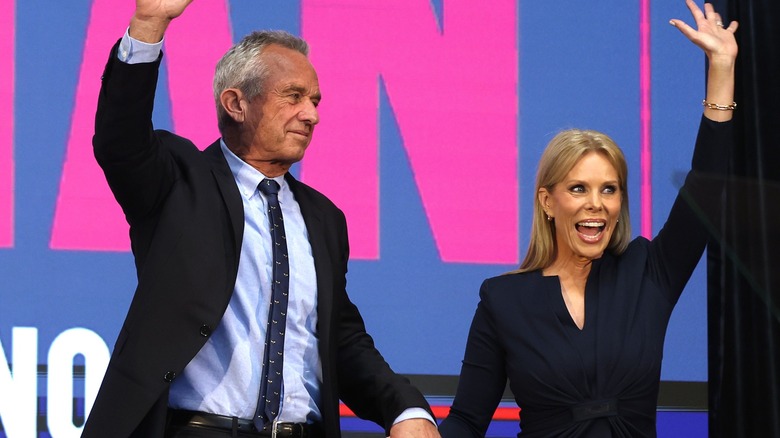 RFK Jr. and Cheryl Hines smiling, waving