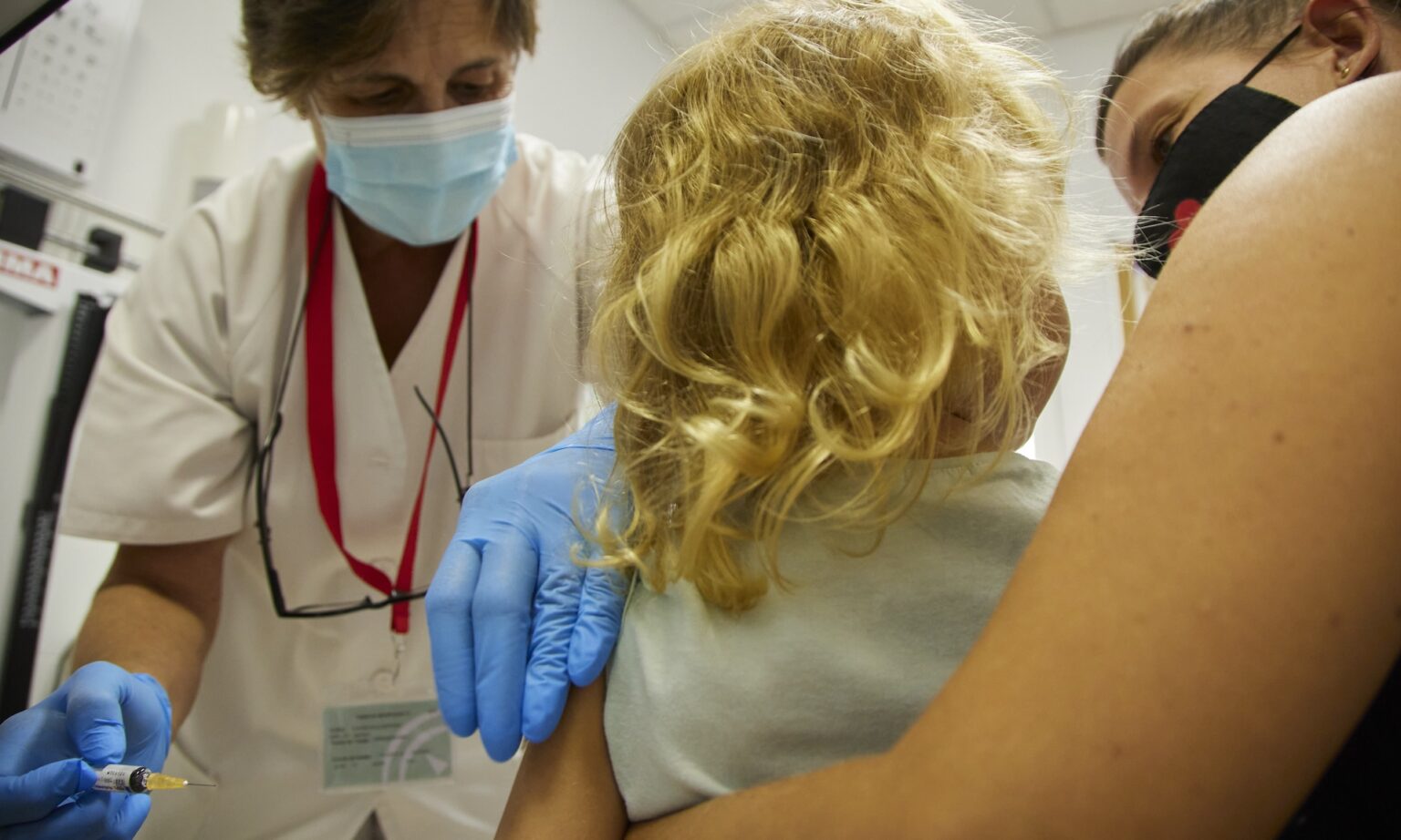 A young girl receives the flu vaccine