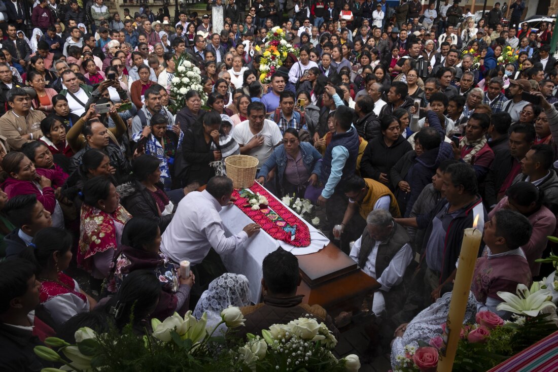 People gather around the coffin of slain Catholic priest and activist Marcelo Pérez during a mass at the main plaza in San Andrés Larráinzar, Chiapas state, Mexico, on Monday.