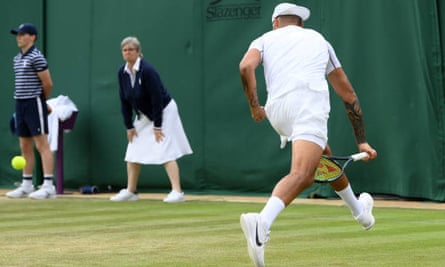 Wendy Smith on duty as Nick Kyrgios plays a shot through his legs in a second round match at Wimbledon, 30 June 2022