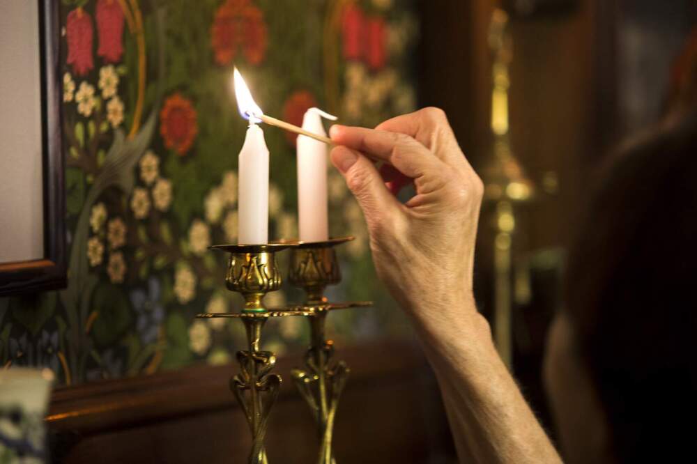 The lighting of Shabbat candles before dinner to usher in the Jewish Sabbath. (Jesse Costa/WBUR)